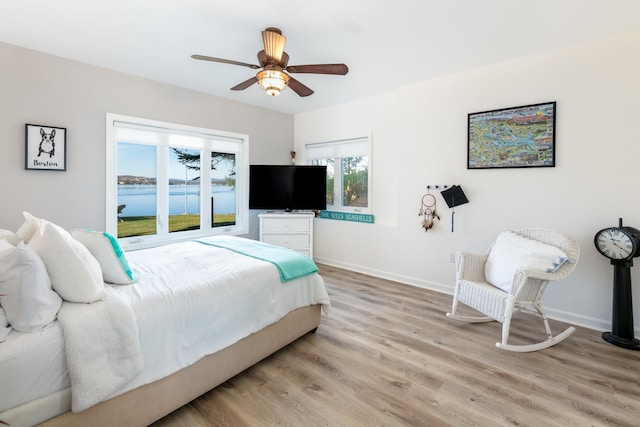 bedroom with ceiling fan and light hardwood / wood-style flooring