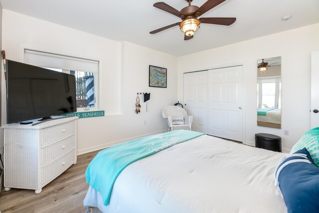 bedroom with ceiling fan, a closet, and wood-type flooring