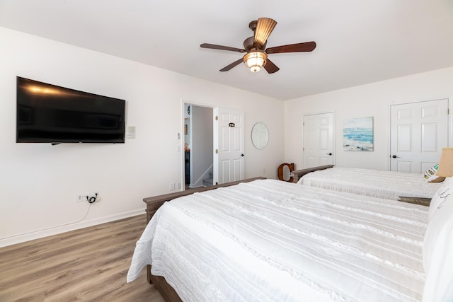 bedroom with hardwood / wood-style floors and ceiling fan