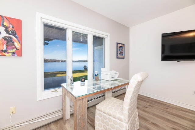 dining space featuring hardwood / wood-style flooring and a baseboard heating unit