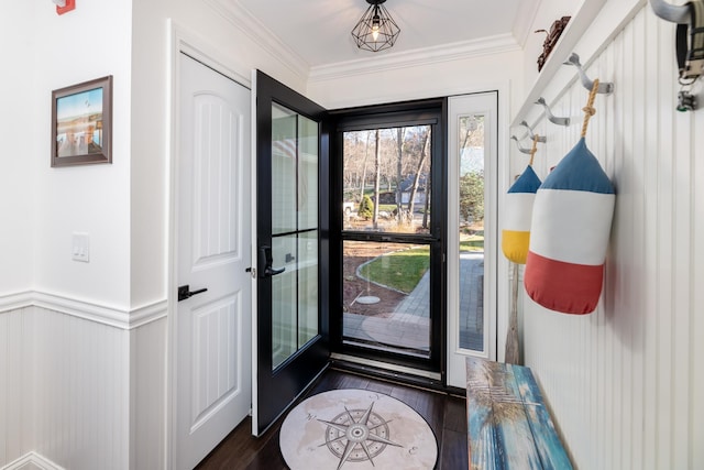 doorway to outside featuring dark hardwood / wood-style floors and crown molding