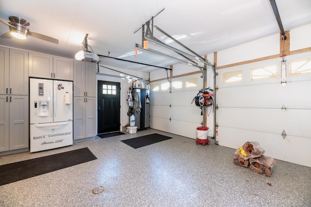 garage with ceiling fan, white fridge with ice dispenser, and a garage door opener