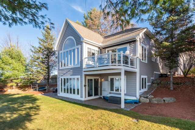 back of house with a balcony, a yard, and a patio