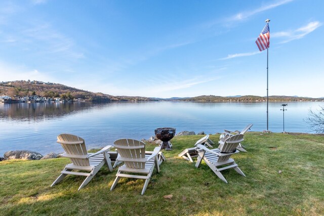 dock area with a yard and a water view