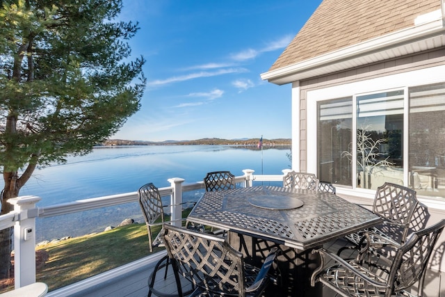 wooden terrace featuring a water view