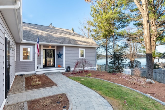 view of front of house with a water view