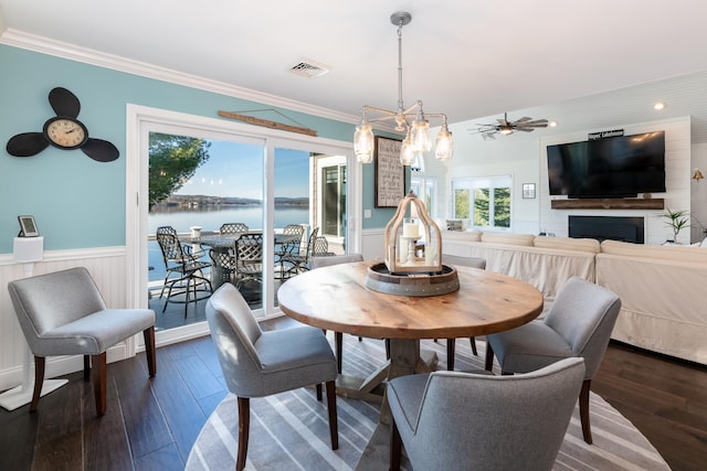 dining area featuring crown molding, dark hardwood / wood-style flooring, and ceiling fan with notable chandelier