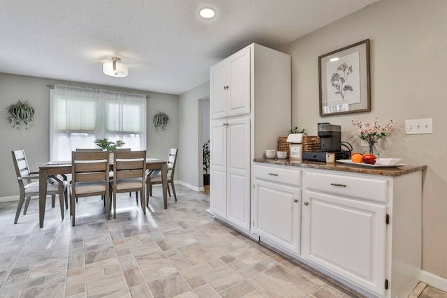 dining area with a textured ceiling