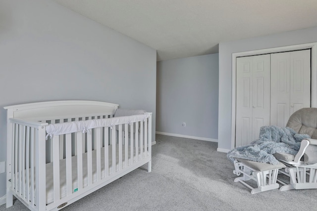 carpeted bedroom with a closet and a nursery area