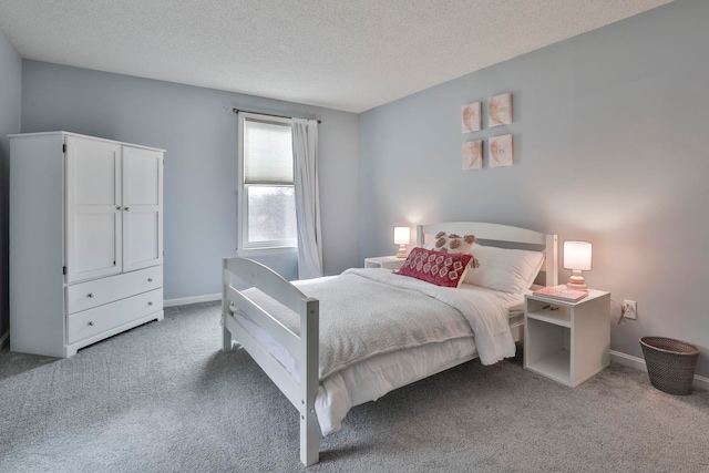 bedroom with carpet and a textured ceiling