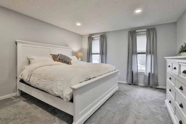 carpeted bedroom with a textured ceiling