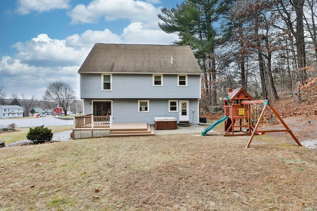 back of house with central air condition unit, a wooden deck, a yard, a playground, and a hot tub