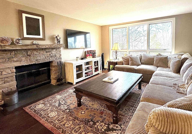 living room with a fireplace and dark wood-type flooring