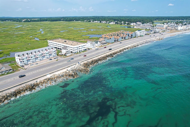 drone / aerial view featuring a water view and a beach view