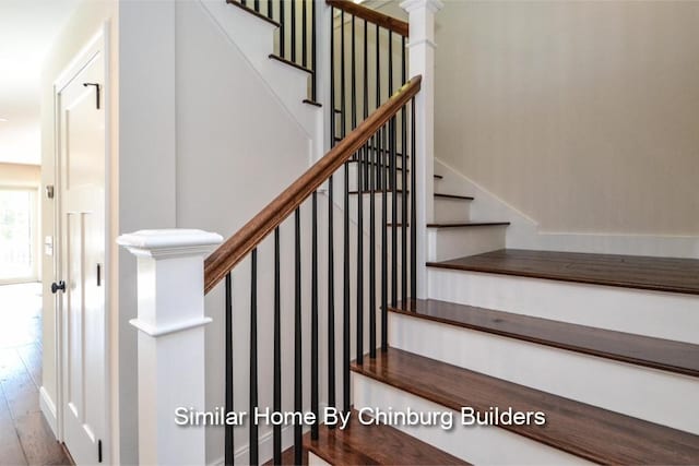 stairway featuring hardwood / wood-style flooring