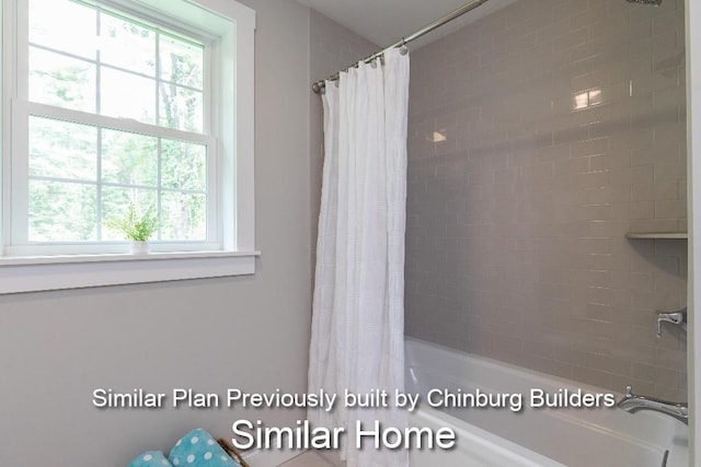 bathroom with shower / tub combo and plenty of natural light