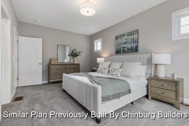 bedroom with light colored carpet