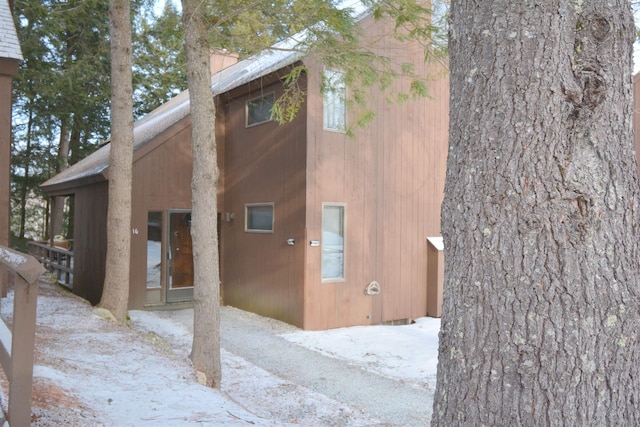 view of snow covered back of property