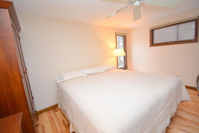 bedroom with ceiling fan and light hardwood / wood-style floors