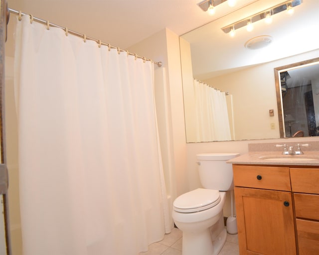 bathroom featuring tile patterned flooring, vanity, and toilet