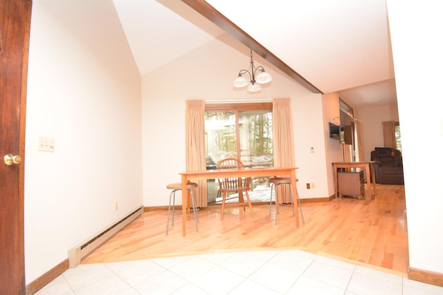 dining space with a chandelier, light tile patterned floors, a baseboard radiator, and lofted ceiling