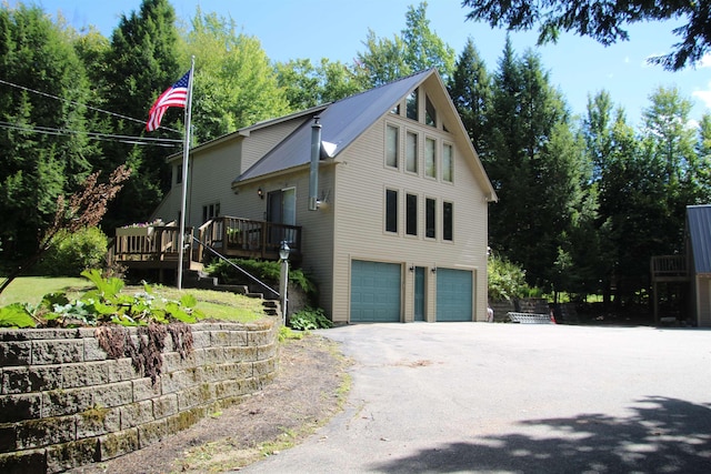 view of side of home featuring a wooden deck and a garage