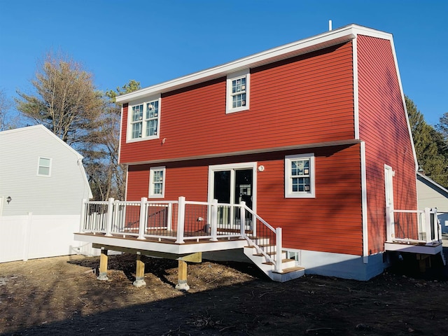 rear view of property featuring a wooden deck