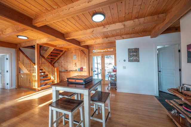 43 Upton Rd, Dover, VT 05356 - dining space featuring wood finished floors, wood walls, stairway, a wooden ceiling with exposed beams, and french doors