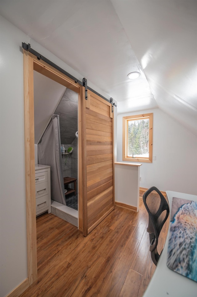 43 Upton Rd, Dover, VT 05356 - bedroom featuring a barn door, wood finished floors, and vaulted ceiling