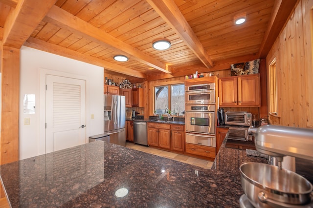 43 Upton Rd, Dover, VT 05356 - kitchen featuring stainless steel appliances, a warming drawer, brown cabinets, dark stone counters, and a wooden ceiling with exposed beams