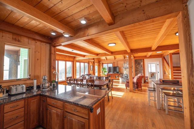 43 Upton Rd, Dover, VT 05356 - kitchen featuring open floor plan, healthy amount of natural light, light wood-type flooring, brown cabinetry, and a wood ceiling with exposed beams