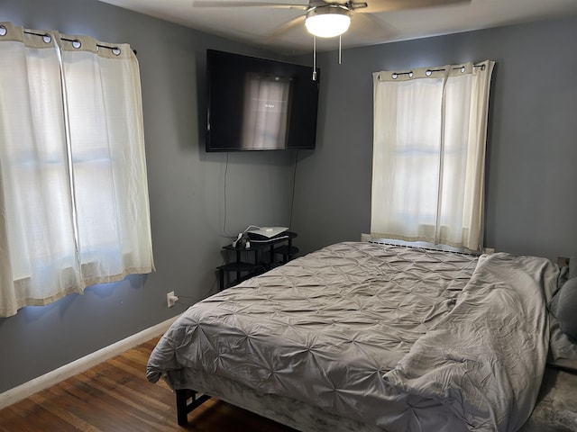 bedroom featuring ceiling fan and dark wood-type flooring