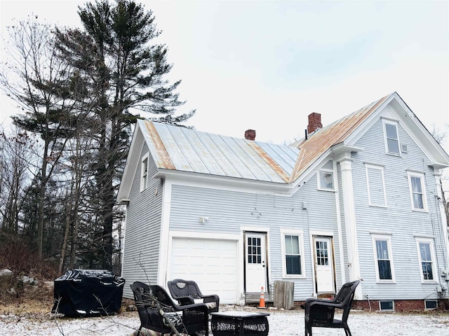 back of house with a garage