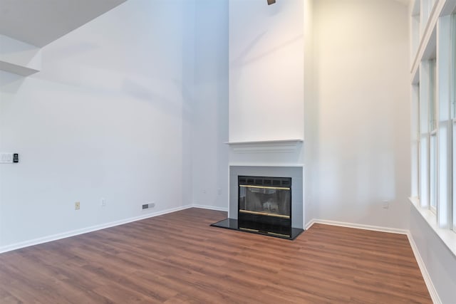 unfurnished living room featuring dark wood-type flooring