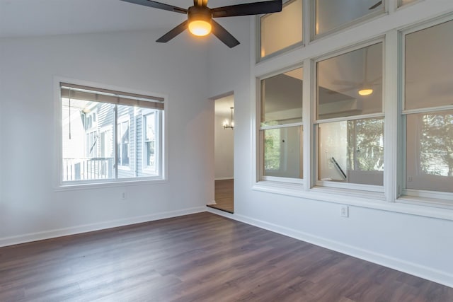 unfurnished room with vaulted ceiling, dark hardwood / wood-style flooring, and ceiling fan with notable chandelier