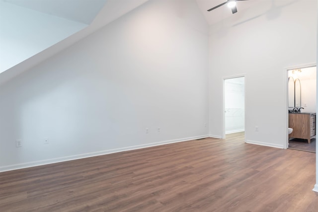 additional living space with ceiling fan, dark wood-type flooring, and high vaulted ceiling