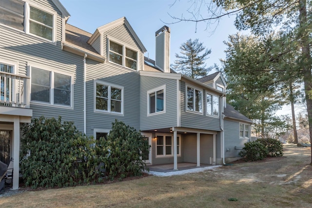 rear view of property featuring a patio area