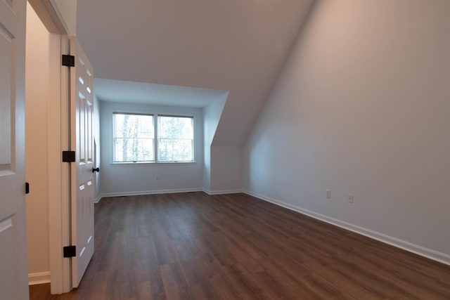 bonus room with lofted ceiling and dark hardwood / wood-style floors