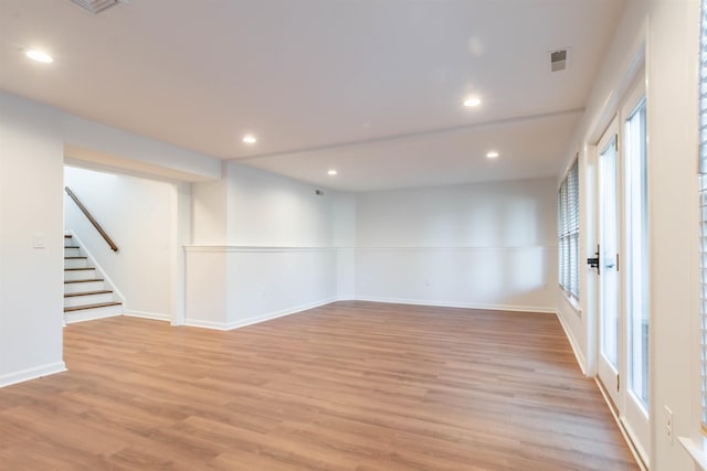 spare room with light hardwood / wood-style floors and a healthy amount of sunlight