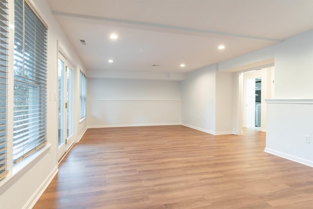 spare room with light hardwood / wood-style flooring