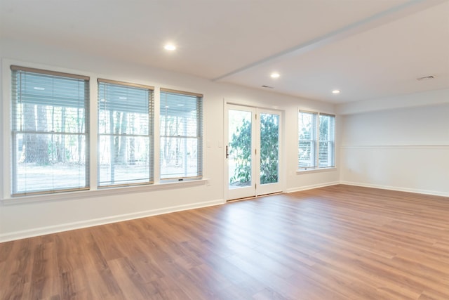 unfurnished room with hardwood / wood-style flooring