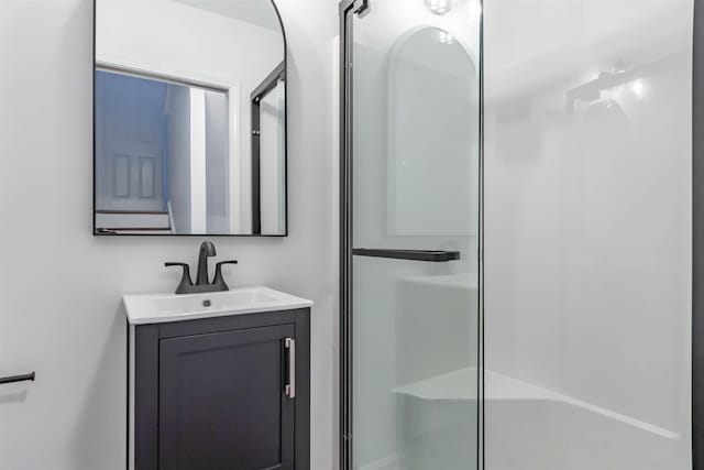 bathroom featuring vanity and an enclosed shower