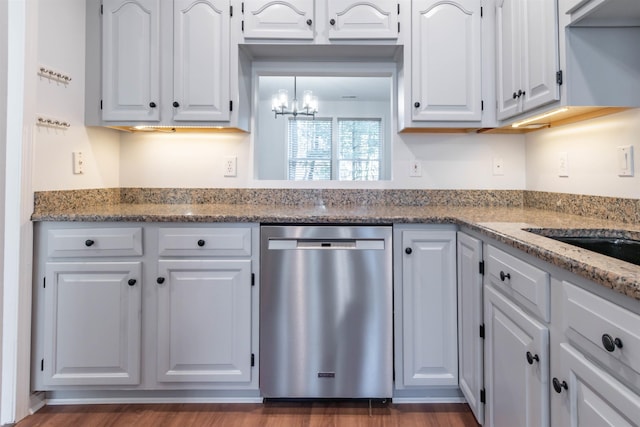 kitchen featuring stainless steel dishwasher, light stone countertops, white cabinetry, and a chandelier