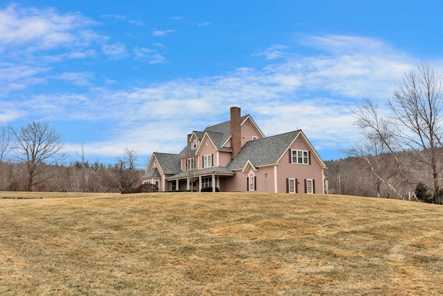 back of property featuring a lawn