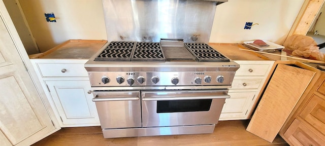 kitchen with range with two ovens and light hardwood / wood-style flooring