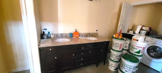 bathroom with vanity and washer / clothes dryer