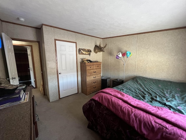 bedroom with carpet, ornamental molding, and a textured ceiling