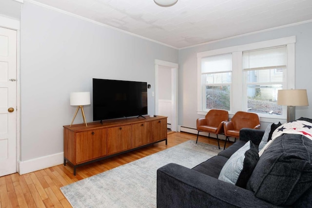 living room with a baseboard heating unit, crown molding, and light hardwood / wood-style flooring