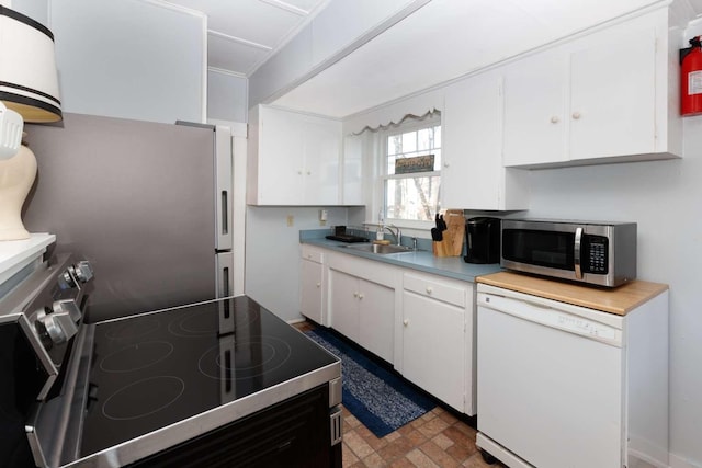 kitchen featuring white cabinetry, sink, and stainless steel appliances