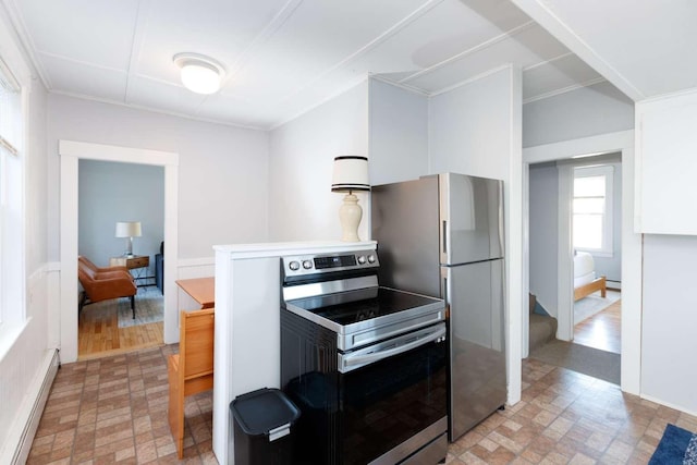 kitchen featuring stainless steel appliances, a baseboard radiator, and crown molding